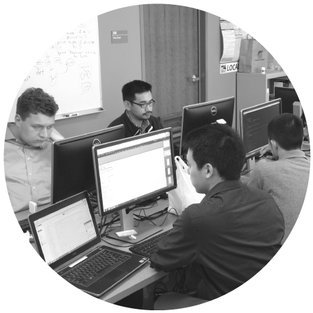 group of IT interns working on computers